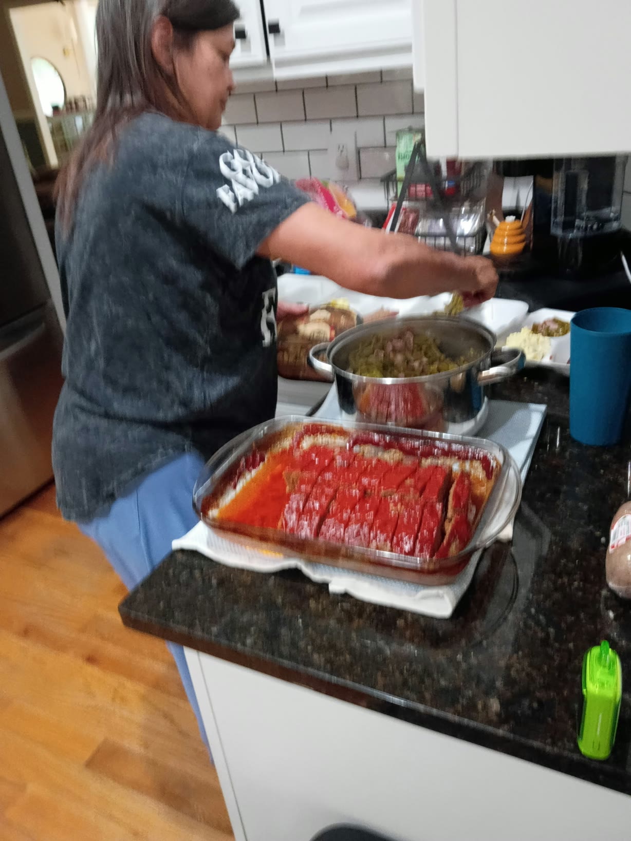 Tracy preparing food beside a large pot and tray
